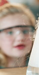 Girl, beaker and smoke with science for homework, education and goggles with chemistry. Child, test tube and fluid with ppe glasses, liquid or development for learning with school assignment at house