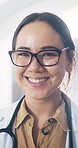 Face, doctor and woman in hospital, smile and career ambition with healthcare protocols. Employee, professional and person in clinic, happiness and about us for medical service and hygiene compliance