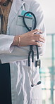 Arms crossed, hands and stethoscope with woman doctor in hospital for health or medical wellness. Confident, consulting and trust with healthcare professional in clinic for appointment or checkup