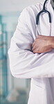 Arms crossed, hands and trust with doctor man in hospital for health or medical wellness. Confidence, consulting and stethoscope with healthcare professional in clinic for appointment or checkup
