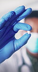 Medical, pill and hand in hospital with glove, care plan or health treatment with medication. Healthcare, man or doctor with capsule, dosage option or recovery prescription in pharmaceutical solution