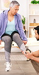 Mature, woman and physiotherapist in clinic with ankle pain, rehabilitation and medical assistance. Person, foot injury and orthopedic worker in consultation with help, wellness or healthcare support