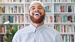 Face, funny and Muslim man in library as scholar for religious information or study. Happy, Islamic person and laughing in bookstore for development or research of Arabic culture and language