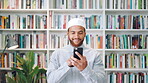 Muslim man, phone and smile with scholar in library for religious information or study. App, text message and typing with Islamic person in bookstore for online search of Arabic culture and language