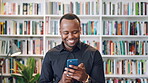 Teacher, man and phone in college library with education, laugh and check text message for funny joke. Happy, black person and educator scroll on campus with tech, humor or mobile app for university.