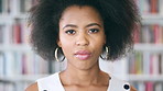 Black woman, face and student in library for education at college by bookshelf, confident and serious at campus. Girl, pride and portrait for learning, scholarship or study at university in Kenya