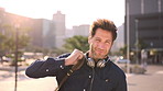 Face, travel and businessman with backpack in city, commuting and pride for music production career. Outdoor, sound engineer and happy person with headphones, creative and employee with smile in USA