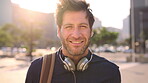 Face, commuting and businessman with backpack in city, travel and pride for music production career. Outdoor, sound engineer and happy person with headphones, creative and employee with smile in USA