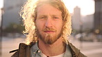 Face, college student and man in city for commute, education and learning for academic scholarship. Serious, wind and scholar with portrait for study opportunity, knowledge growth or travel to campus