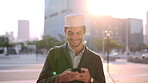 Business, laugh or Muslim man in city with phone, online chat or comic post on social media. Happy, Arab person or employee in town with tech, funny text message or meme reaction in travel routine.