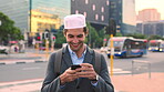 Muslim man, smile and phone in city for scroll, chat and social media browse online with internet. Outdoor, mobile app and connection with tech for communication, networking and message for contact