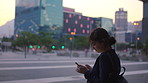 Night, businesswoman and commute in city with phone, typing text message and social media update. Bokeh, evening and person in windy urban town with tech, email notification and travel from work.
