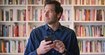 Face, phone and thinking with man in library as college or university professor for education. App, future and learning with mature teacher in bookstore for academic job, knowledge or research