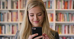 Student, woman and scroll in library with phone, reading college email and check social media update. Happy, female person and browsing on campus with tech, university education or website for course