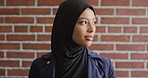 Education, face and smile of Muslim woman on brick wall background at university campus. Belief, faith and learning with happy student at college for Arabic, Islamic or religious studies as scholar