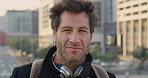 Business, face or man in city with pride, about us or confidence in advertisement industry. Happy, wind or marketing specialist with headphones, career growth or opportunity in brand management.