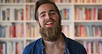 Laugh, man and face of student in library with confidence for university education by bookshelf. Happy, knowledge and portrait of male person with pride for college scholarship on campus in Germany.