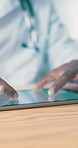 Tablet, man and doctor in hospital, hands and healthcare with research for diagnosis. Person, professional and physician in clinic, telehealth and digital app for patient files and medical report