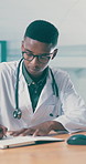 Doctor, healthcare and writing with black man in hospital for assessment, consulting or review. Insurance, notebook and report with medical professional at desk in clinic for support or wellness