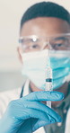 Doctor, medical and black man with vaccine syringe for safety, virus prevention or treatment. Tap needle, person or covid immunity, protection or prepare medicine with face mask in healthcare clinic