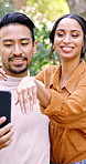 Phone, video call or couple with wedding ring in park, engagement announcement or share good news. Laugh, tech or happy people with virtual chat to show jewelry, relationship update or proposal story