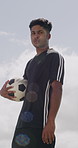 Soccer, sports and face of man with ball outdoor for playing game, training and practice for match. Serious, athlete and portrait of person with catch for exercise, challenge and fitness for club