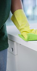 Hands, cleaning and person with table in office, hygiene and remove dust for surface sanitation. Cleaner, gloves or cloth in workplace for counter disinfection, cleanliness and wiping dirt for health