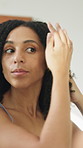 Mirror, haircare and woman in home bathroom with natural texture, shampoo or hair moisturiser. Reflection, curly hairstyle or morning routine of person for self care, wellness and grooming for beauty