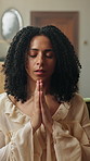 Religion, woman and faith with prayer in home for spiritual belief, gratitude or sign of cross. Christian, person and worship in house for holy guidance, praise Jesus Christ or thankful for salvation