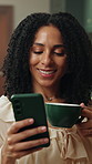 Woman, relax and phone in home with coffee, reading morning news and smile for text message response. Happy, person and warm drink in living room with tech, social media notification and wellness.