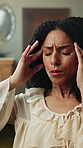 Woman, headache and home with stress for overworked strain, anxiety or mental health on sofa. Frustrated, female person or pain with migraine or sore head for vertigo, dizziness or pressure in house