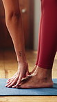 Woman, hands or stretching with feet on yoga mat in home for fitness, exercise or flexibility. Female person, yogi or reaching toes with balance or body warm up for indoor pilates, health or wellness