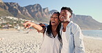 Laugh, black couple and pointing with hug on beach for romantic getaway, sightseeing and scenery. Vacation, love and happy people with embrace on sand for exploring, sea view and healthy relationship