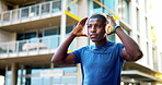 Headphones, fitness and black man in city with music, podcast or playlist for runner, exercise or wellness. Audio tech, athlete and male person listening to album or radio for cardio workout in town.