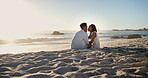 Relax, travel and couple at beach with kiss, love and partner affection on tropical holiday. Space, smile and black people at ocean with care, commitment and healthy relationship on getaway vacation