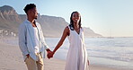 Happy, black couple and walk on holiday at beach for honeymoon trip, connection and bonding. Support, people and holding hands at seaside for romantic stroll, summer vacation and healthy relationship