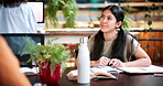 Student, woman and discussion in college with study group, education or knowledge for homework task. University, person and talk in library with textbooks, project and learning for skill development.