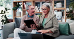 Happy, discussion and old couple in house with tablet, life insurance website and retirement planning. Senior, married people and conversation on couch with tech, estate policy and asset management.