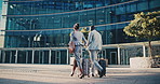 Business people, travel and team at city with luggage, talking and walking together for journey. Suitcase, man and woman outdoor in town with conversation for project, back and commute on work trip