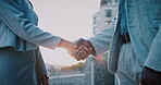 Real estate, greeting or people in city with handshake, intro or deal close in sale agreement. Hello, business or realtors with shaking hands, property exchange or success in investment negotiation.