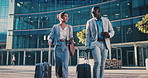 Business people, travel and talking in city with suitcase, team and walking with phone for journey. Luggage, man and woman outdoor with conversation for project, smile and commute on work trip
