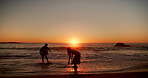Beach, playing and couple with splash at sunset for bonding on vacation, holiday and travel together. Dating, sea and man with woman with waves for playful relationship, connection and summer weekend