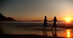 Ocean, running and couple holding hands at sunset for bonding on vacation, holiday and travel. Dating, beach and man with woman with love for relationship, connection and romantic moment on weekend