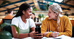 Laugh, college and phone with women in library for gossip, social media and viral post. University app, bonding and student sorority update with friends on campus for communication, books and news