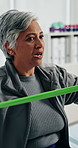 Old woman, physiotherapist and resistance band at clinic for recovery, stretching and muscle wellness. People, smile and helping hand with rehabilitation for injury, support and talk in retirement