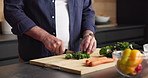 Cooking, hands and vegetables with person in kitchen of home for healthy meal preparation. Cutting, food and knife with senior man at counter in apartment for cuisine, culinary hobby or recipe