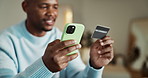 Man, hands and phone in home with credit card, check CVV details and payment for online shopping. Person, typing and digital banking in living room with tech, ecommerce discount and eft transaction.