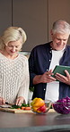 Vegetables, cooking and old couple with tablet, chopping board or laugh with recipe guide. Tech, senior man and woman with meal prep, cut ingredients or online tutorial for vegan diet in home kitchen