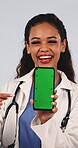 Doctor, face and happy woman with phone, green screen and wellness website recommendation in studio. White background, medical professional or person with mobile, thumb up and healthcare presentation