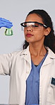 Thinking, scientist and liquid in studio for chemistry, research and medical study with experiment. Woman, observation or goggles with beaker, chemical reaction and testing sample on white background